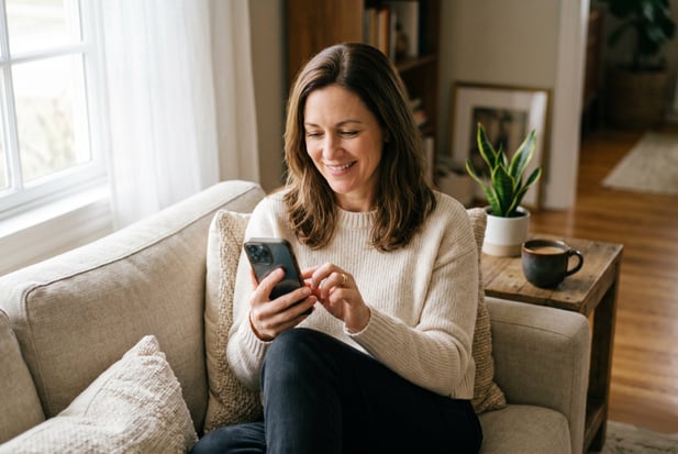 Patient comfortably completing a digital medical intake form at home on her smartphone