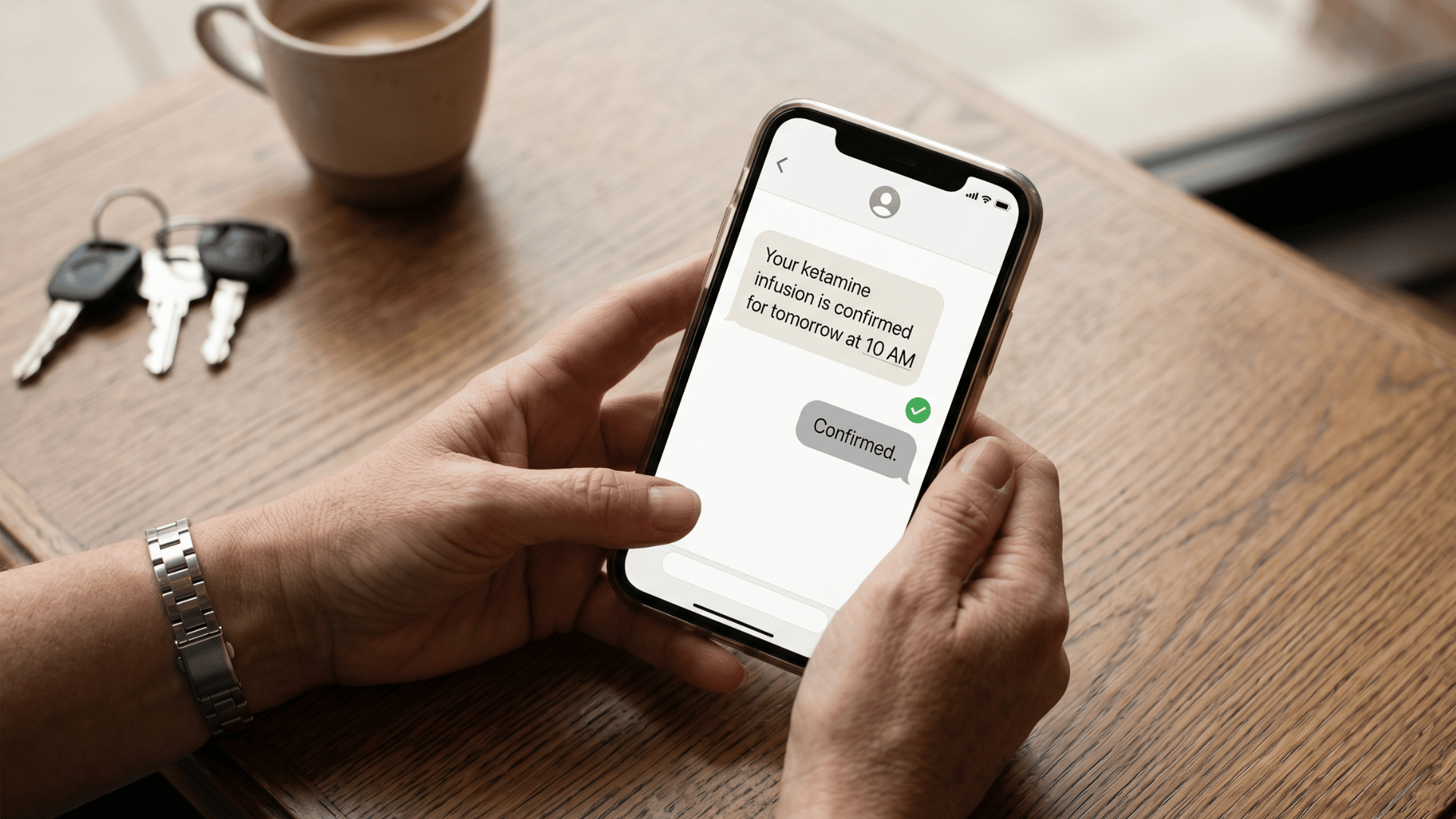 Patient confirming ketamine infusion appointment via SMS text message on smartphone