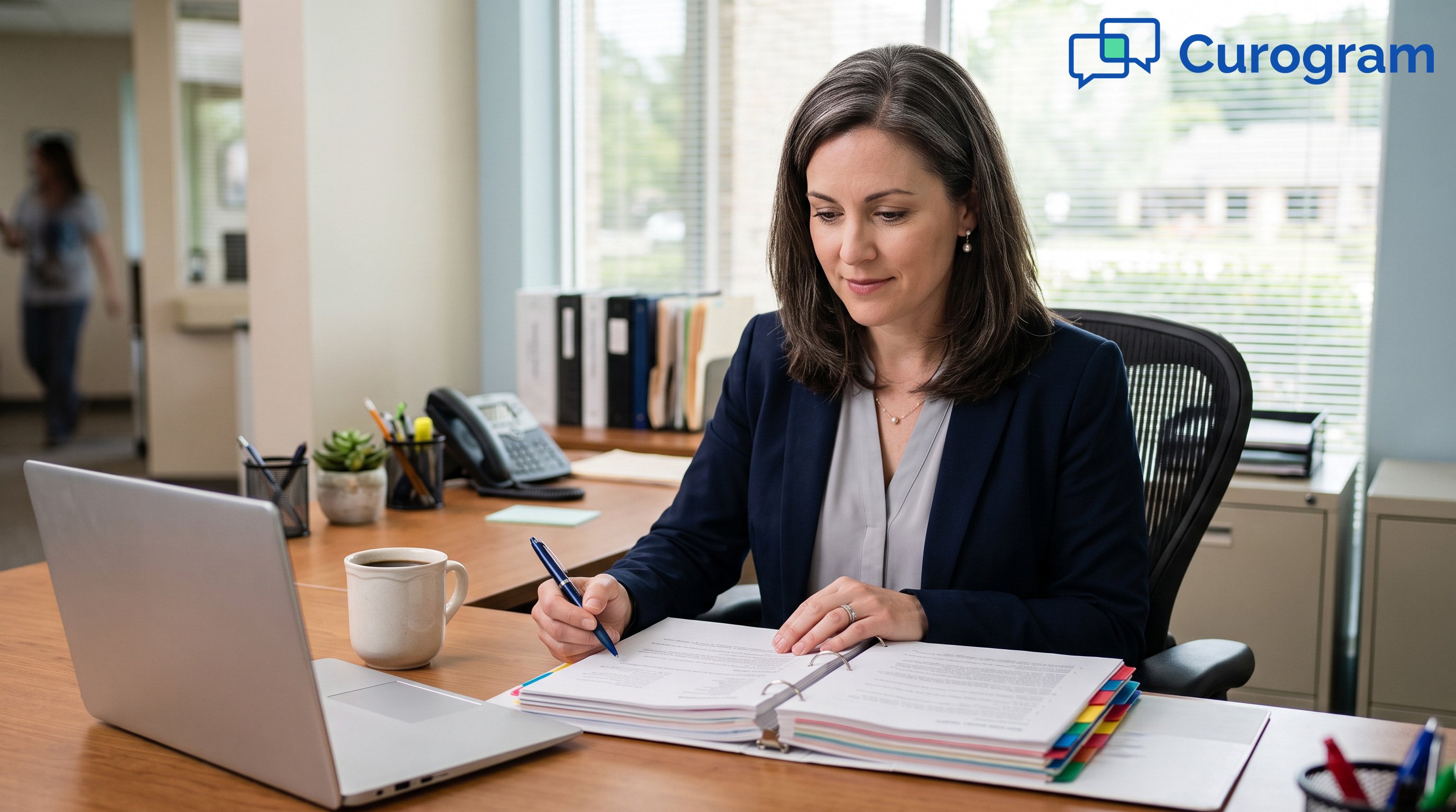 Medical practice manager reviewing a compliance binder at a clinic desk