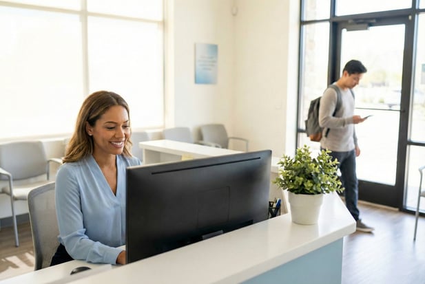 Medical receptionist at a front desk, illustrating staff managing patient experience and reviews