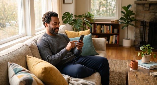 Patient at home on couch using a smartphone app for convenient medical intake