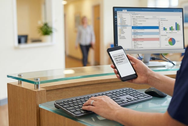 Healthcare reception desk with a computer monitor managing patient reviews and SEO
