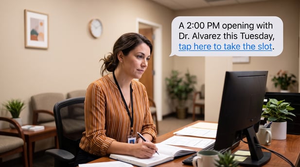 Coordinator seated at a clinic workstation looking at notes, with ample copy space