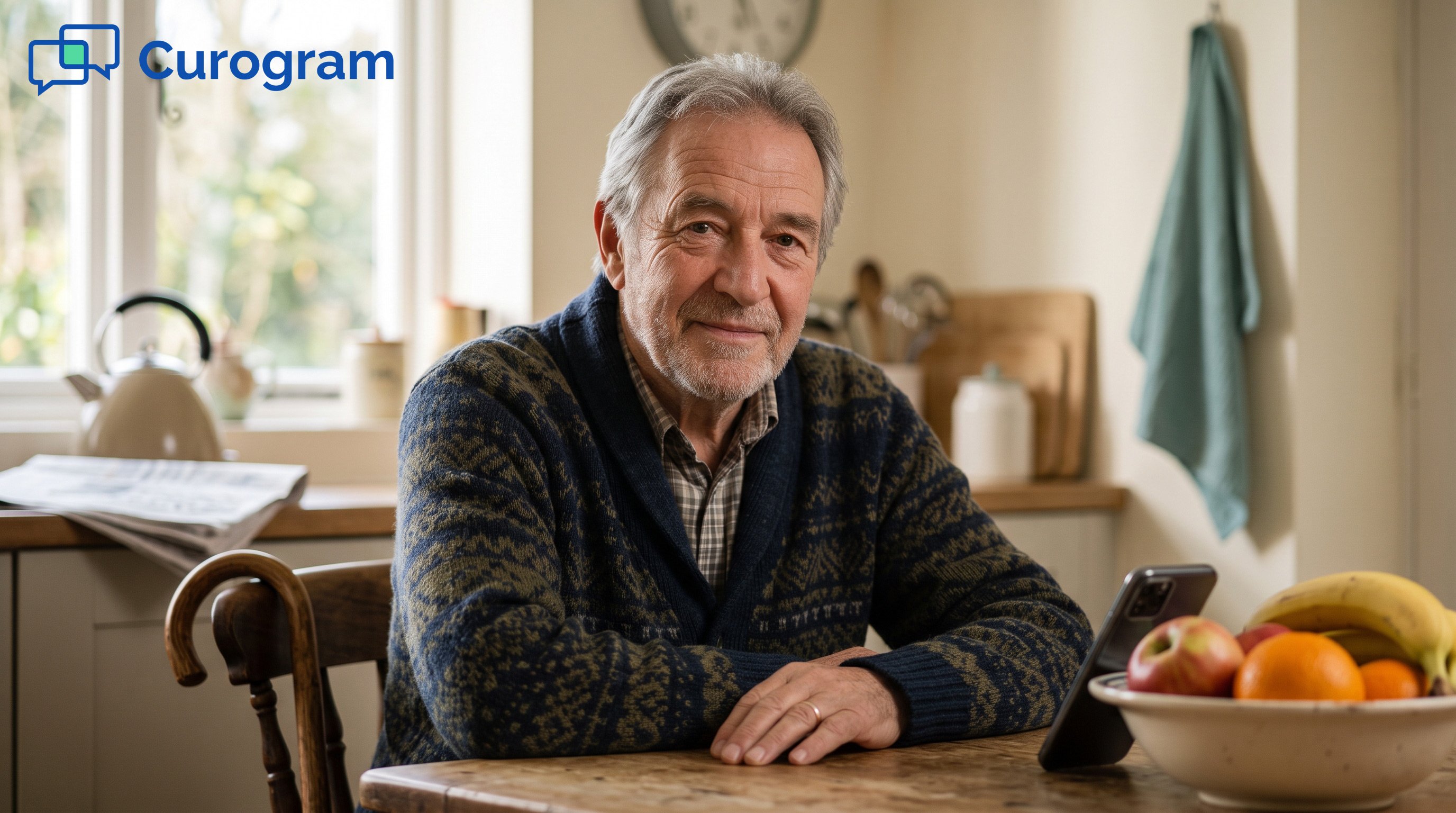 Smiling senior man in blue patterned cardigan at kitchen table
