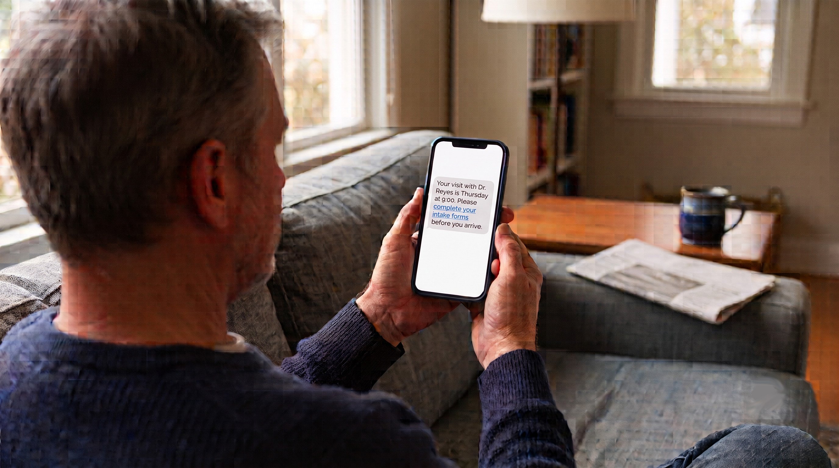 Patient reading a SMS intake text right at home