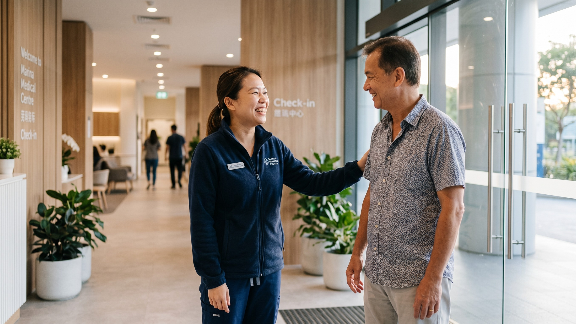 Staff member warmly welcoming a returning patient back to a medical practice