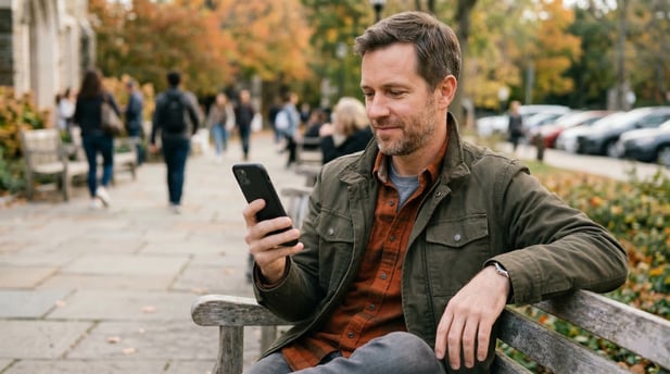 Relaxed man on a park bench holding a phone with a green payment confirmation screen