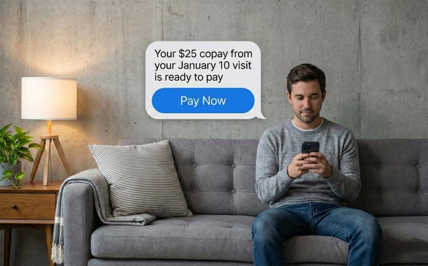 Man relaxing at home looking at a mobile patient bill payment text message