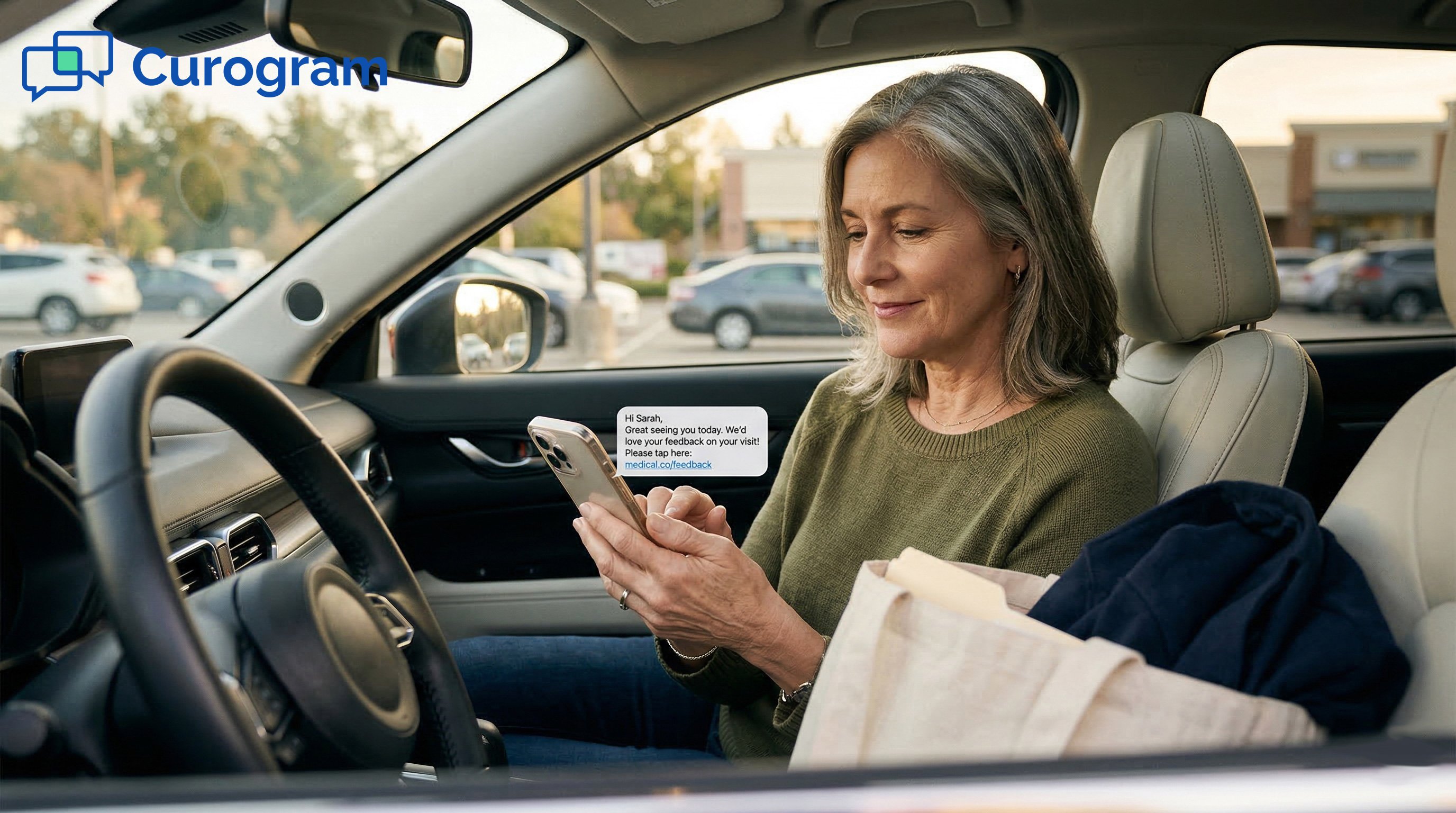 Older patient viewing a post-visit text notification on her phone in her car