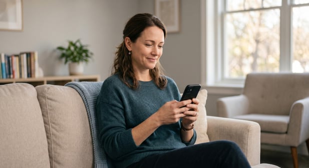 A happy patient paying their behavioral health bill easily on a smartphone