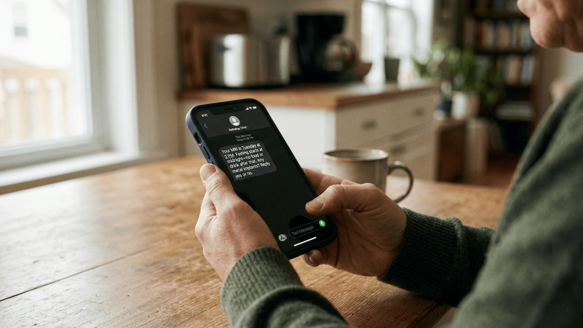Patient reading MRI prep text message at home before imaging appointment