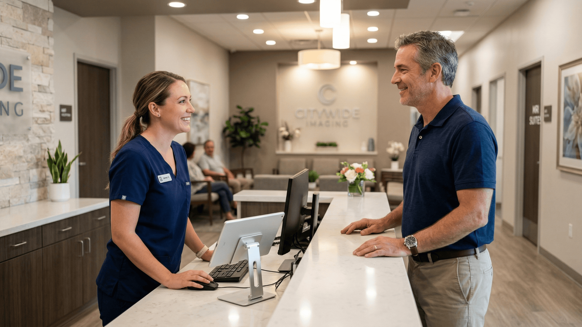 Patient checking in at imaging center front desk without paperwork using digital intake