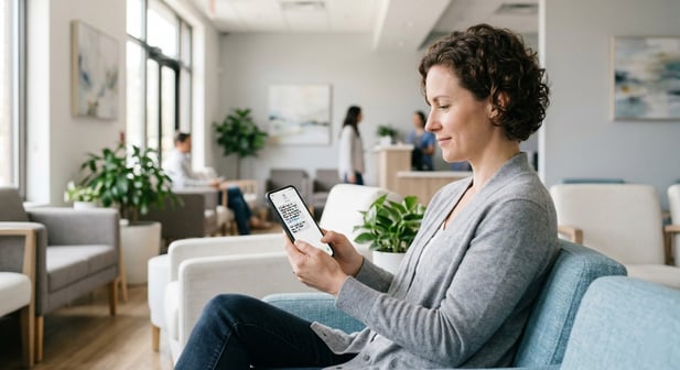 Patient in clinic checks phone for survey request after visit