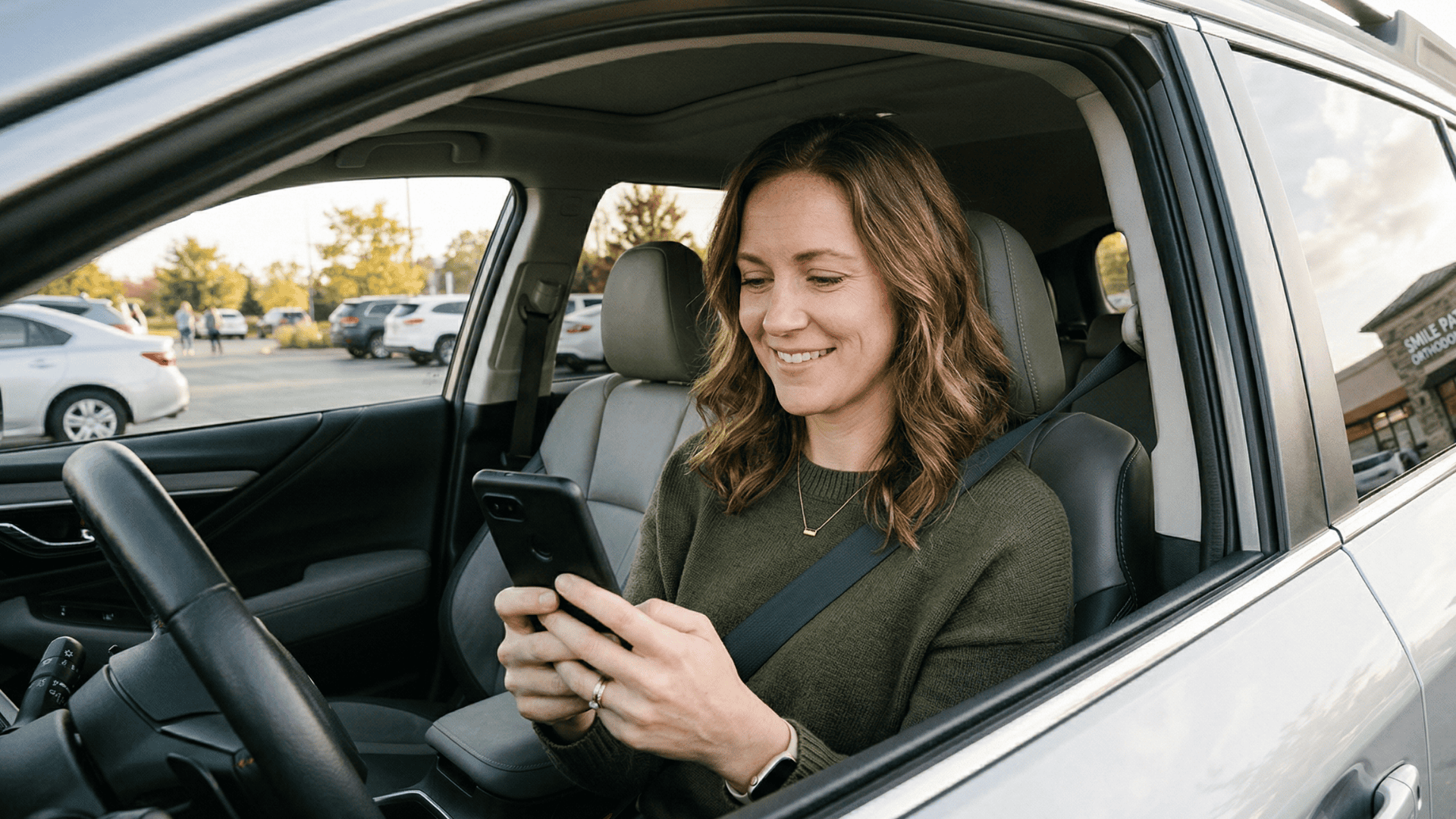 Orthodontic front desk staff member wrapping up a patient visit at the reception counter