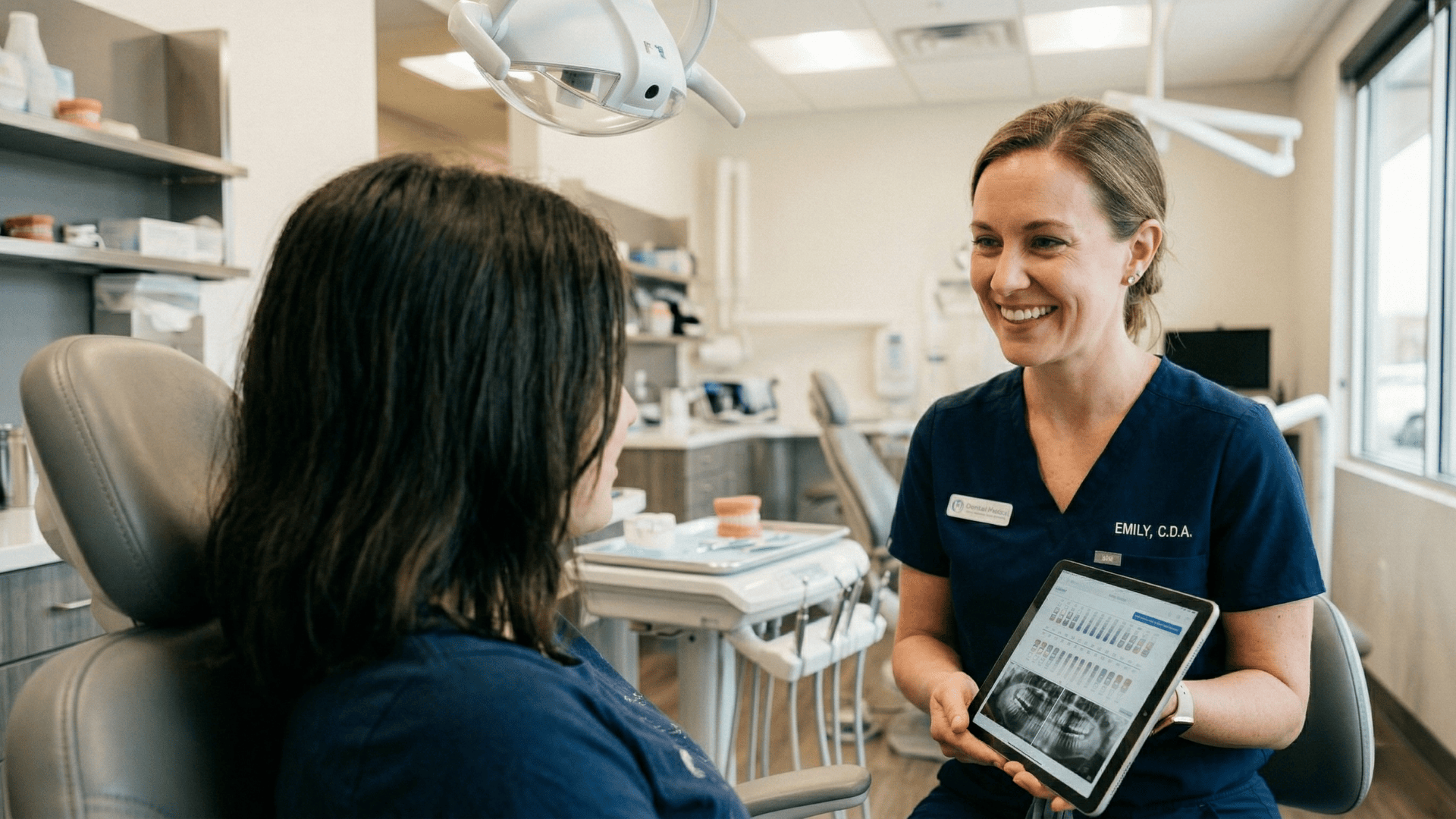 Orthodontic staff reviewing retainer check details with a teen patient during an office visit