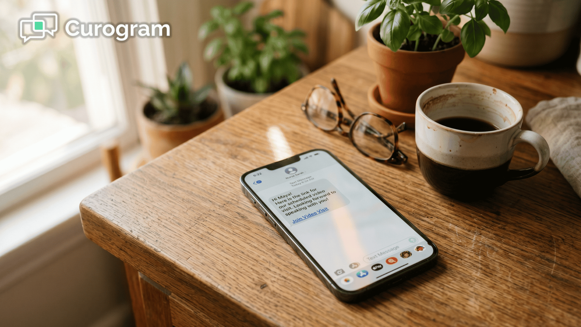 Smartphone showing text-link telemedicine visit invitation on a kitchen counter at home