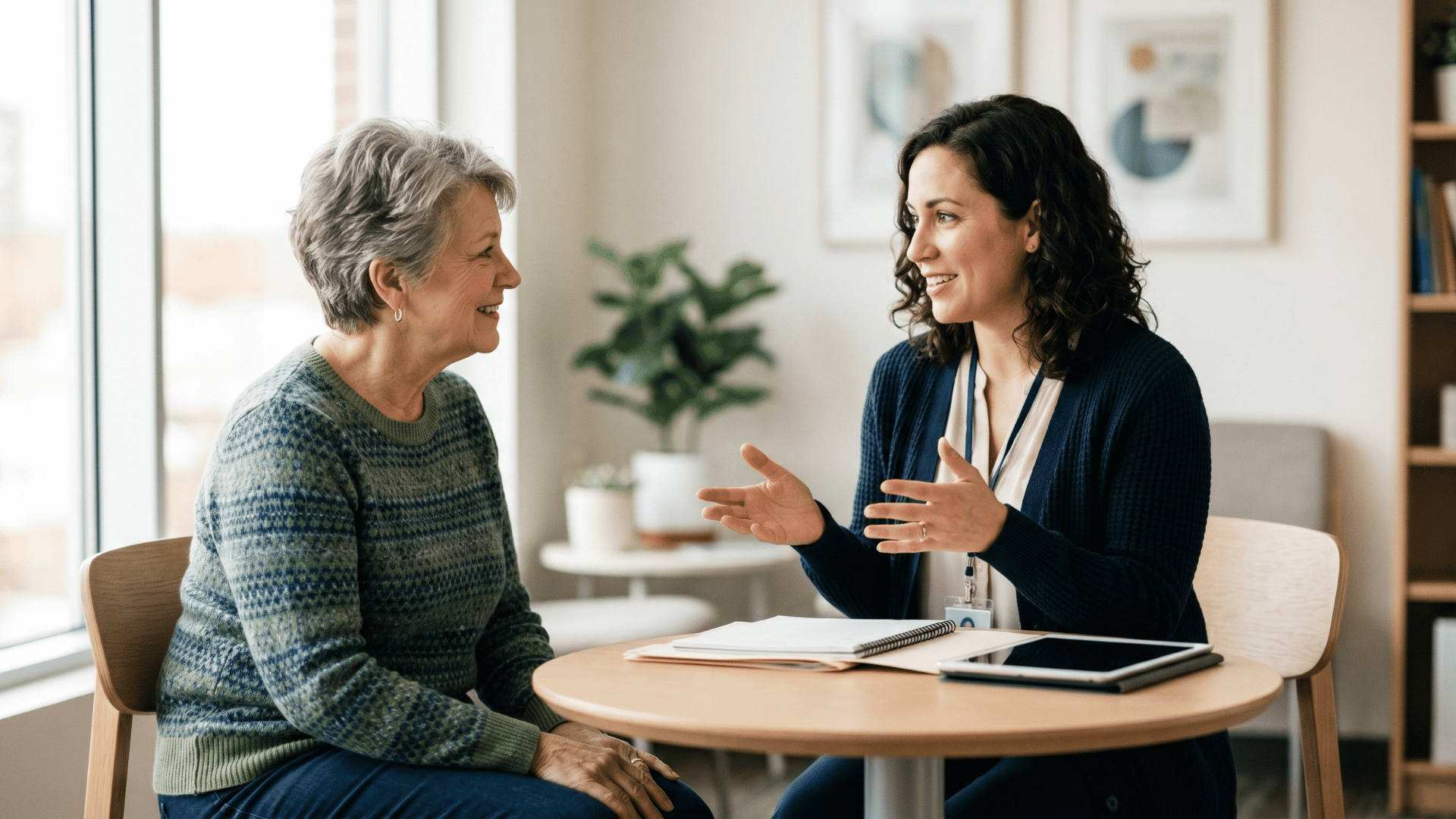 Billing coordinator explaining a bill to a patient in a bright clinic