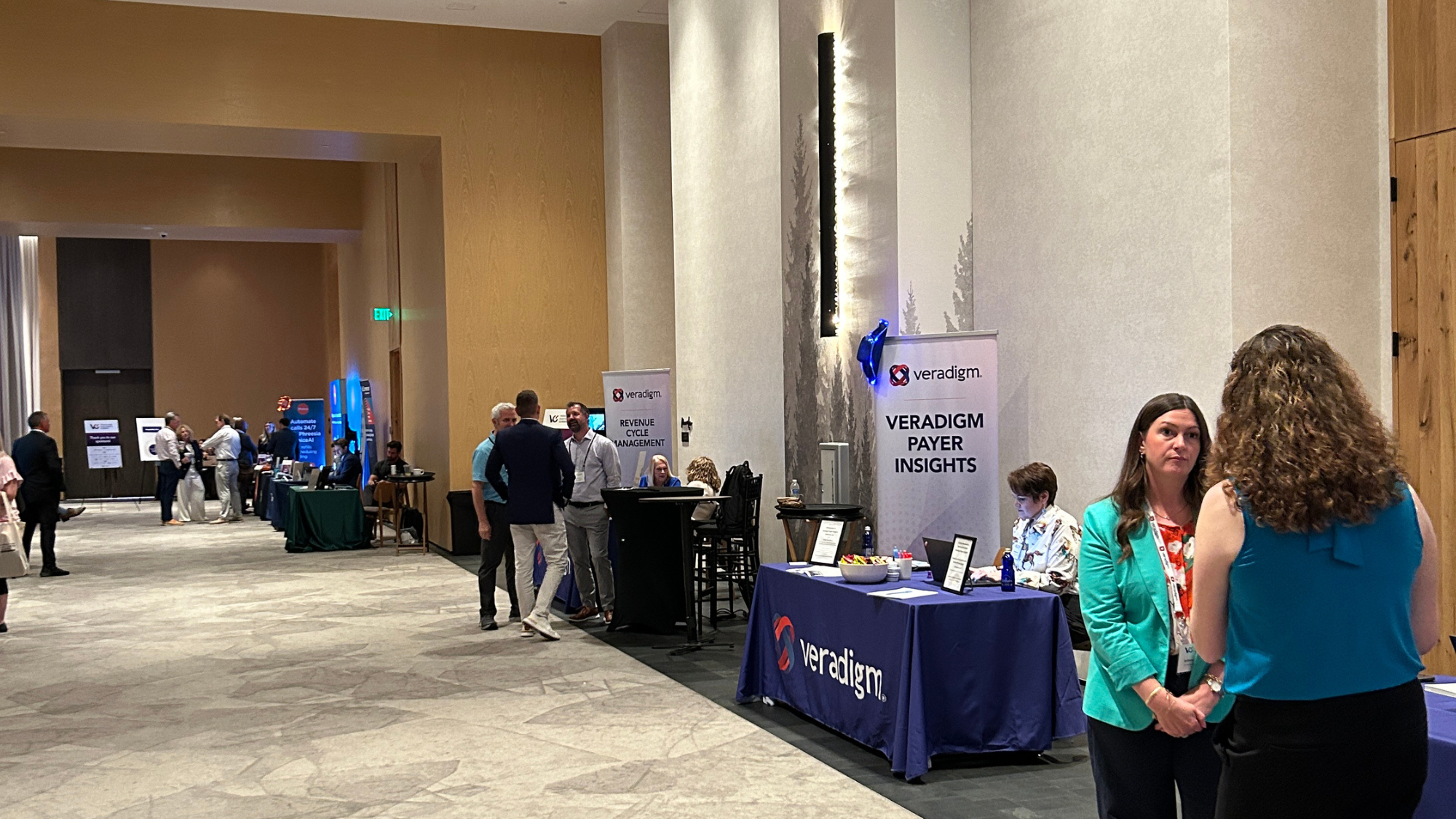 A professional conference hall featuring a Veradigm exhibition booth